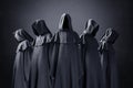 Group of five scary figures in hooded cloaks