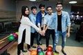 Group of five south asian peoples having rest and fun at bowling club. Putting their hands together, friends showing unity and