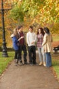 Group Of Five Teenage Friends Chatting In Park