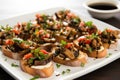 group of flavored mushroom bruschetta on a white plate Royalty Free Stock Photo