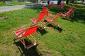 Group of folding wooden hammock chairs on the lawn in foot in the alley in front of restaurant by the river on waterfront. the cyc Royalty Free Stock Photo