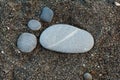 Group of foot by pebble on sand background Royalty Free Stock Photo