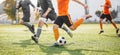 Group of Football Players Running and Kicking League Match. Adult Football Players Compete in Soccer Game Royalty Free Stock Photo