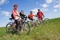 A group of four adults on bicycles.