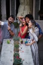 Group of four adults having fun at the outdoor bar, taking selfie with funny props. Fun, party, socializing, multiethnic, concept