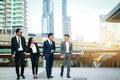 A group of four Asian businessmen Standing meeting for discussions on real estate investment in Asia.