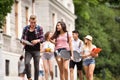Group of attractive teenage students walking to university. Royalty Free Stock Photo