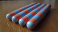 A group of four blue and orange striped toothpicks on a table, AI