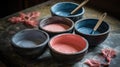 a group of four bowls with different colors of paint in them