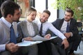 Group of four business people sitting on sofa. They couldn`t be happier about working together Royalty Free Stock Photo