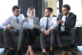 Group of four business people sitting on sofa. They couldn`t be happier about working together Royalty Free Stock Photo