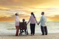 Group of four cheerful elderly old senior have trip outdoor, happy disabled senior elderly woman in wheelchair travel with friends Royalty Free Stock Photo