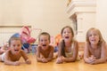 The group of four children lying on the floor. Four happy children lie on the floor. Royalty Free Stock Photo