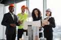 Group of four colleagues standing near building complex prototype project Royalty Free Stock Photo