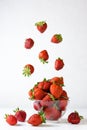 Fresh strawberries with flying berries on a white background.