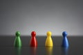 Group of four figurines in different colors in a row Royalty Free Stock Photo