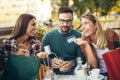 Group of four friends having fun a coffee together Royalty Free Stock Photo