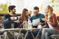 Group of four friends having fun a coffee together. Royalty Free Stock Photo