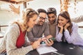 Group of four friends having fun a coffee together. Royalty Free Stock Photo