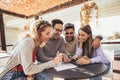 Group of four friends having fun a coffee together. Royalty Free Stock Photo