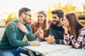 Group of four friends having fun a coffee together. Royalty Free Stock Photo