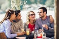 Group of four friends having fun a coffee together. Royalty Free Stock Photo