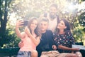 Group of four friends taking selfie with a smart phone Royalty Free Stock Photo