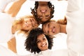 Group of four happy multiethnic friends looking at camera Royalty Free Stock Photo