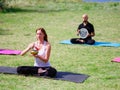 A group of four holds yoga classes in the park. Healthy lifestyle. Royalty Free Stock Photo