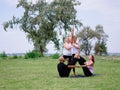 A group of four holds yoga classes in the park. Healthy lifestyle. Royalty Free Stock Photo