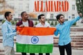 Allahabad city inscription. Group of four indian male friends with India flag making selfie on mobile phone. Largest India cities