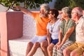 Group of four mature people having fun together taking a selfie and looking at the camera smiling - senior enjoying their Royalty Free Stock Photo