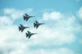 Group of four military aircraft of fighters, jet airplane in the sky make maneuvers Royalty Free Stock Photo