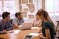 Group of four millenials in meeting Royalty Free Stock Photo