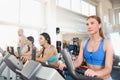 Group of four people in the gym, exercising their legs doing cardio training Royalty Free Stock Photo