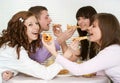 Group of four people with pizza and juice