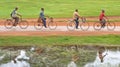 Group of four people riding bike or cycling and the reflection o