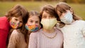 Group of four school-age girlfriends wearing protective masks await end of pandemic lockdown and back to normality