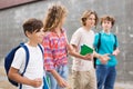 Group of four teens going home from school Royalty Free Stock Photo