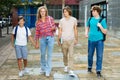 Group of four teens going home from school Royalty Free Stock Photo
