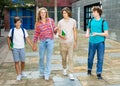 Group of four teens going home from school