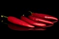 Red hot cayenne chili isolated on black glass Royalty Free Stock Photo