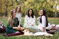 Group of young women having a fun picnic in the park Royalty Free Stock Photo