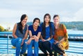 Group of four young women smiling together by lake Royalty Free Stock Photo