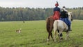 Group of fox hunters on the horses in the autumn field. Reconsruction of traditional horse hunting