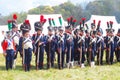 A group of French (Napoleonic) soldiers-reenactors standing in a row.