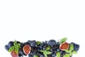 Group of fresh fruits and berries with basil`s on a white background. Royalty Free Stock Photo