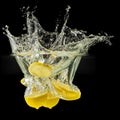 Group of fresh fruits falling in water with splash on black background Royalty Free Stock Photo