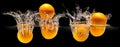 Group of fresh fruits falling in water with splash on black background Royalty Free Stock Photo