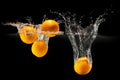 Group of fresh fruits falling in water with splash on black background Royalty Free Stock Photo